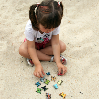 Little girl playing with mini PVC butterflies